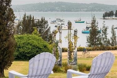 Empty sun chairs overlooking a waterside garden