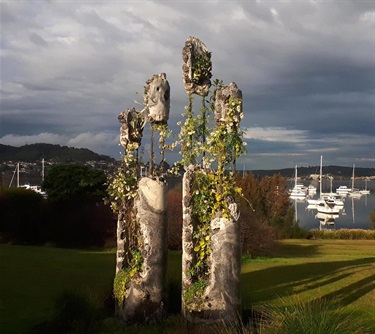 Vines growing through what appears to be derelict concrete pillars.